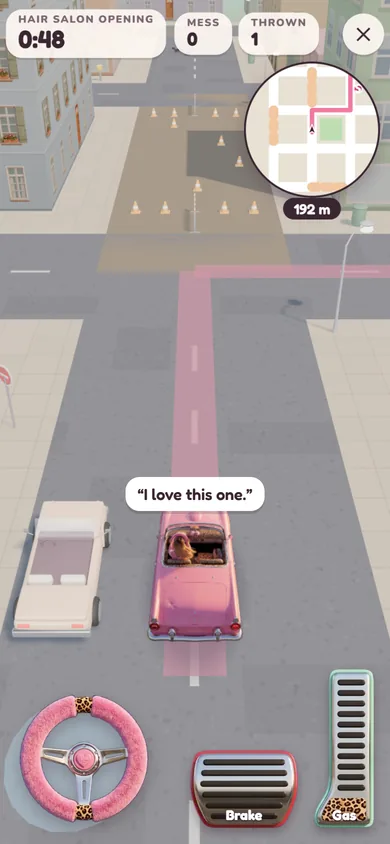 Elodie's pink convertible on a street under roadworks, with the GPS, the furry steering wheel and the pedals